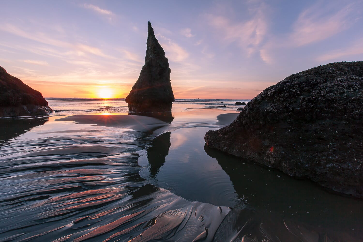 Rock formations at bandon beach in oregon at sunset with a low tide